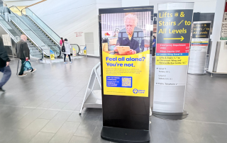Image of a Marie Curie advert on digital screen advert in hospital foyer