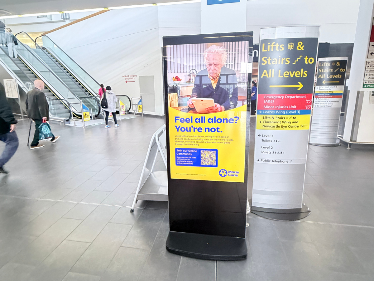 Image of a Marie Curie advert on digital screen advert in hospital foyer