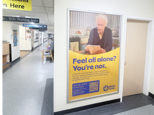 Image of a Marie Curie advert on a poster panel advert in hospital corridor
