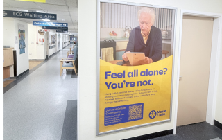Image of a Marie Curie advert on a poster panel advert in hospital corridor