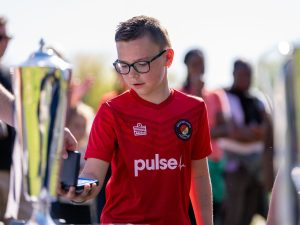 Charlie from the Ebbsfleet United Whites U10s team collecting a medal