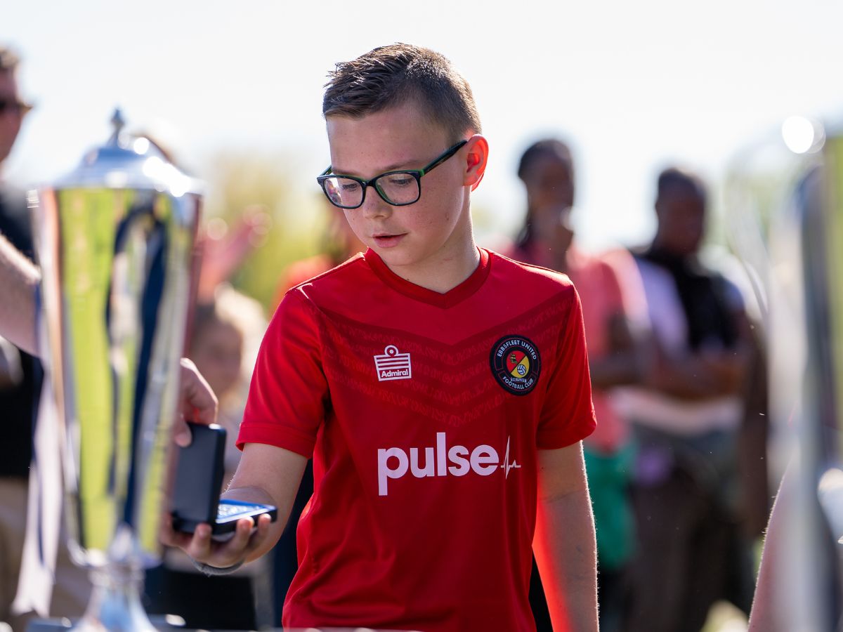 Charlie from the Ebbsfleet United Whites U10s team collecting a medal