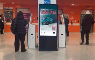 Image of digital screen in hospital entrance with Snows Motor Group car advert