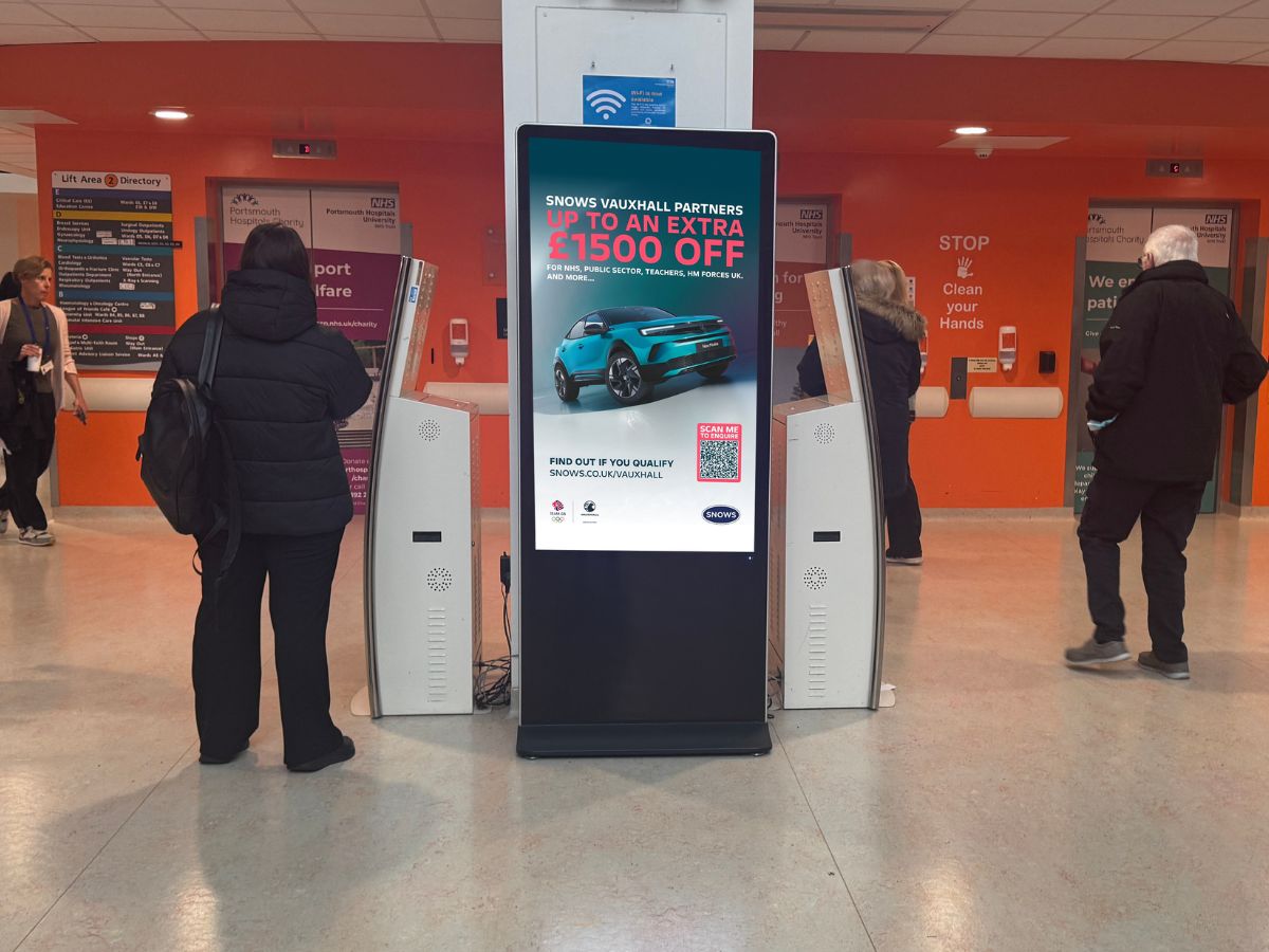 Image of digital screen in hospital entrance with Snows Motor Group car advert